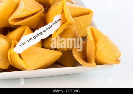 open fortune cookie with strip of white paper - YOU ARE GOING TO MAKE MISTAKES Stock Photo