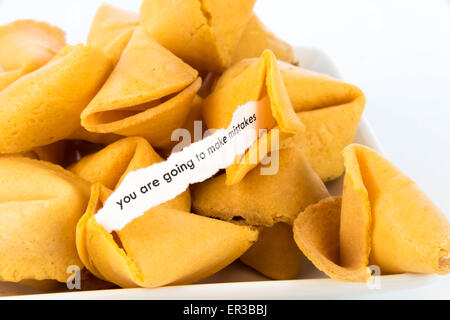 open fortune cookie with strip of white paper - YOU ARE GOING TO MAKE MISTAKES Stock Photo