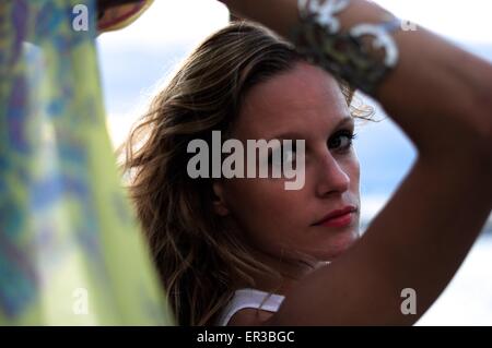 Beautiful woman standing on beach wearing a sarong Stock Photo