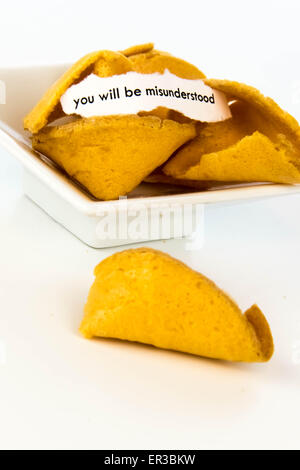 open fortune cookie with strip of white paper - YOU WILL BE MISUNDERSTOOD Stock Photo
