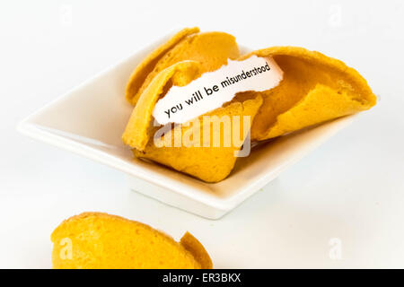 open fortune cookie with strip of white paper - YOU WILL BE MISUNDERSTOOD Stock Photo