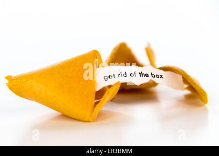 open fortune cookie with strip of white paper - GET RID OF THE BOX Stock Photo