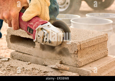 Close-up of a construction worker using an electric grinding tool Stock Photo