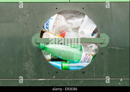 Overflowing entrance full up metal waste container for recycled plastic bottles containers squashed full Stock Photo