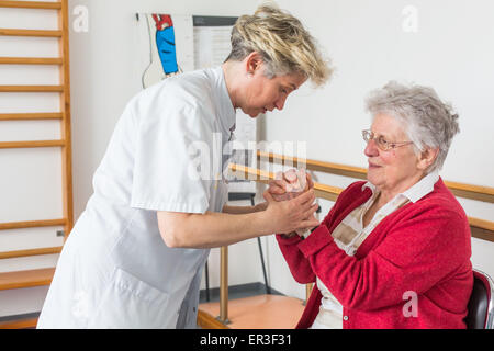 Osteoporosis patient reached in muscle building session with a physiotherapist, Bordeaux hospital, France. Stock Photo