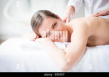 Woman receiving a back massage. Stock Photo