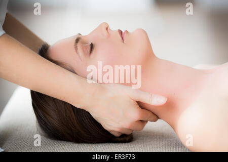 Woman's head being manipulated by an osteopath. Stock Photo