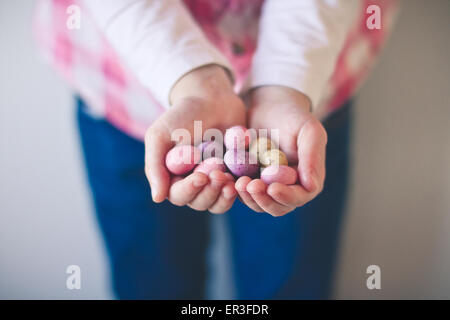Girl holding chocolate Easter eggs in her hands Stock Photo