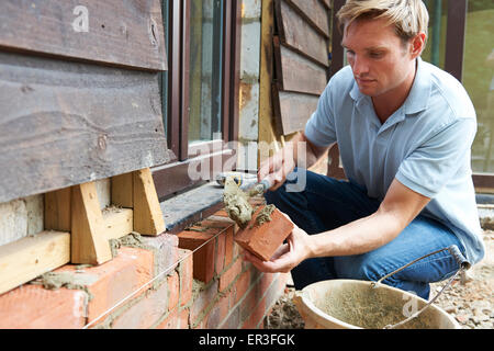 Construction Worker Laying Bricks On Site Stock Photo