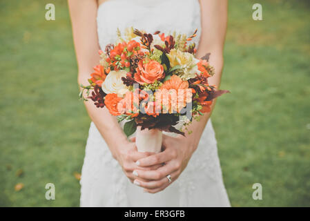 Bride holding bouquet, cropped Stock Photo