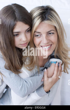 Girl embracing her mother, portrait Stock Photo