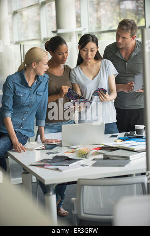 Office workers collaborating on project Stock Photo