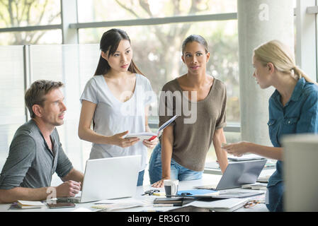 Office workers collaborating on group project Stock Photo