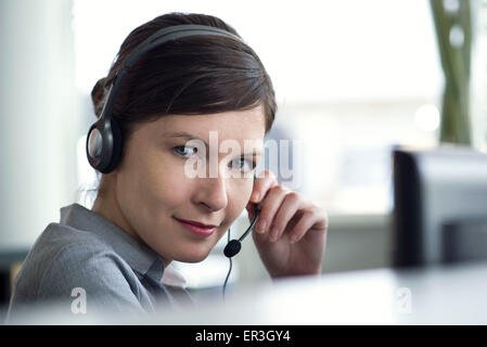 Receptionist using telephone headset Stock Photo