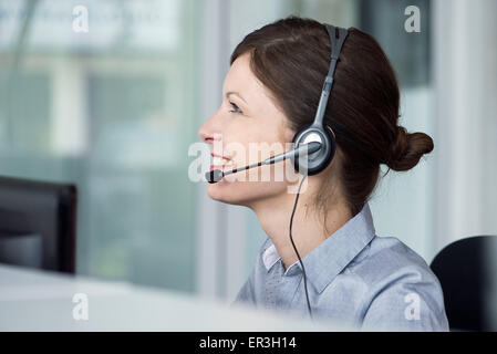 Receptionist wearing headset Stock Photo