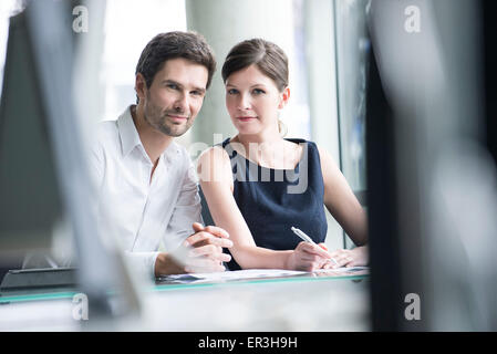 Business associates working closely together Stock Photo