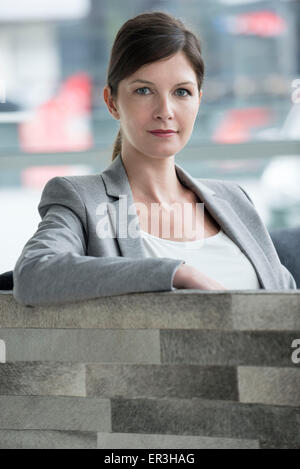 Business woman sitting in armchair Stock Photo