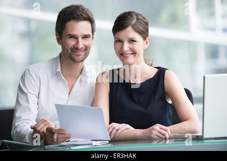 Colleagues reviewing document together Stock Photo