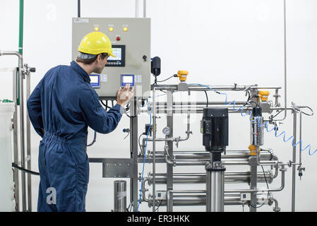 Worker operating industrial equipment Stock Photo