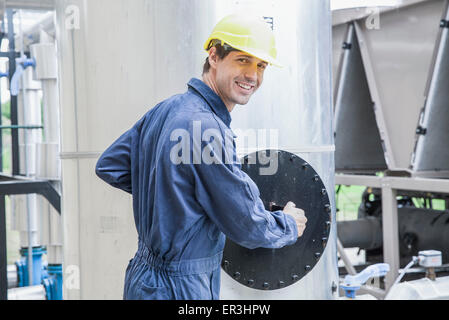 Skilled worker operating incinerator in power generation plant Stock Photo