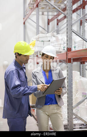 Colleagues discussing plan at warehouse Stock Photo