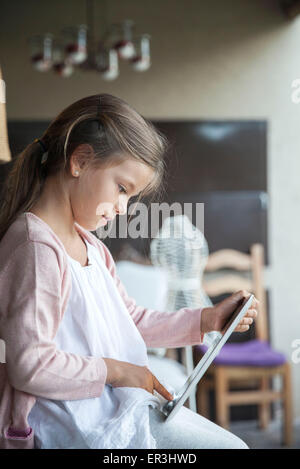 Little girl using digital tablet Stock Photo