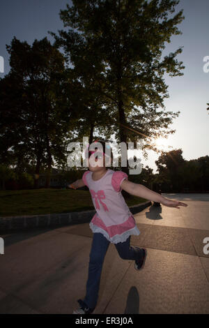 Little girl running in park Stock Photo