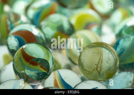 collection of old glass transparent marbles with unique swirls of colored glass trapped inside Stock Photo