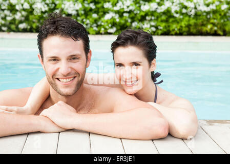 Couple relaxing together in pool, portrait Stock Photo