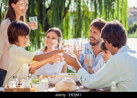 Family enjoying breakfast together outdoors Stock Photo