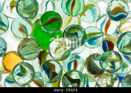 collection of old glass transparent marbles with unique swirls of colored glass trapped inside Stock Photo