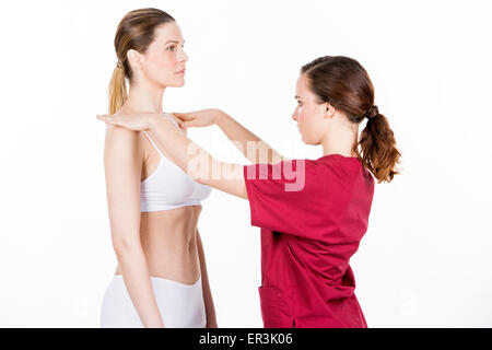 physiotherapist doing a physical examination of a woman Stock Photo