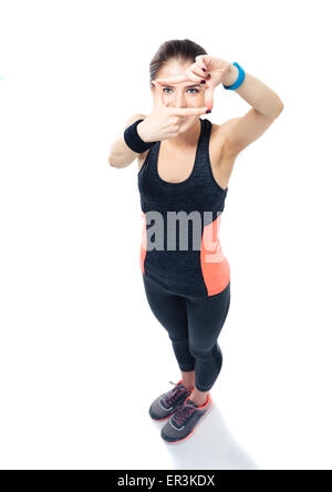 Full length portrait of a sporty young woman making frame with fingers and looking through frame at camera Stock Photo