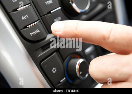 Close Up Of Hand Pressing Car Bluetooth Control On Dashboard Stock Photo