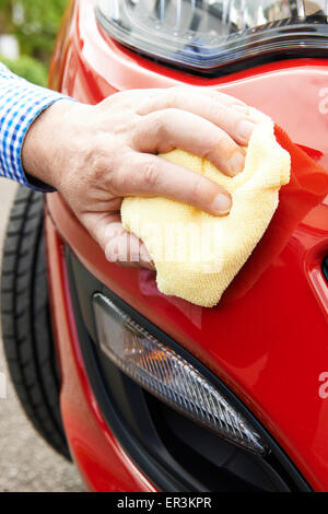Close Up Of Hand Polishing Car Using Cloth Stock Photo