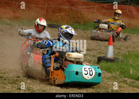 Lawnmower racing using specially tuned and adapted sit-on lawnmowers, racing around a grass circuit in Caldicot,Wales,UK.a sport Stock Photo