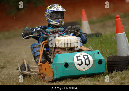 Lawnmower racing using specially tuned and adapted sit-on lawnmowers, racing around a grass circuit in Caldicot,Wales,UK.a sport Stock Photo