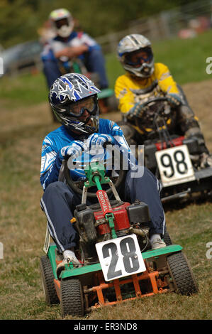 Lawnmower racing using specially tuned and adapted sit-on lawnmowers, racing around a grass circuit in Caldicot,Wales,UK.a sport Stock Photo