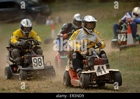 Lawnmower racing using specially tuned and adapted sit-on lawnmowers, racing around a grass circuit in Caldicot,Wales,UK.a sport Stock Photo