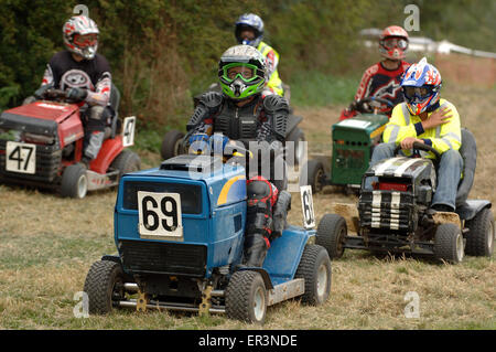 Lawnmower racing using specially tuned and adapted sit-on lawnmowers, racing around a grass circuit in Caldicot,Wales,UK.a sport Stock Photo