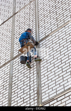 Construction worker working on side of house Stock Photo
