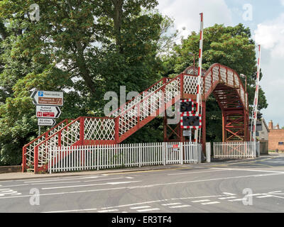 Metal pedestrian footbridge at Oakham railway level crossing, Oakham, Rutland, UK Stock Photo