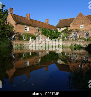 Flatford Mill Field Centre buildings reflected in water on sunny morning, Dedham Vale, Suffolk, England Stock Photo