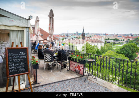 Tourists on the outdoor terrace of a restaurant below the castle, Prague, Czech Republic, Europe Stock Photo