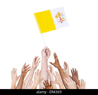 Human hand holding Vatican city flag among multi-ethnic group of people's hand Stock Photo