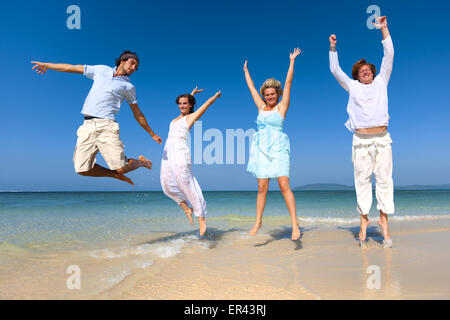 Two couple celebrating on the beach. Stock Photo
