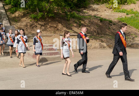 Russian Graduation Group of Russian schoolchildren in traditional uniform celebrating ...