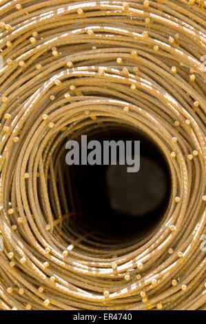 Roll of rusty steel wire mesh for construction. Structural steel for concrete walls. Background Stock Photo