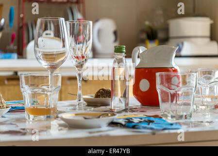 Empty glasses on the table after a good lunch at home in the kitchen Stock Photo