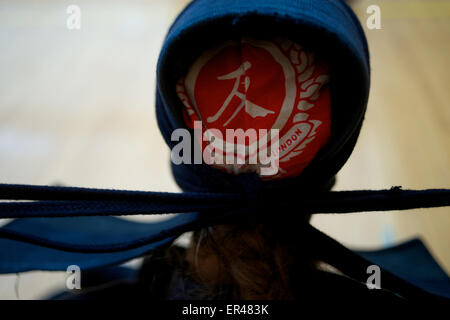 Tokyo, Japan. 27th May, 2015. May 27th 2015, Tokyo. Emily Knight of the GB Kendo Team puts on her protective headgear (men) at a  training session in Tokyo, Japan, for the 16th World Kendo Championships which will be held this weekend May 30-31st. Credit:  Peter Blake/Alamy Live News Stock Photo